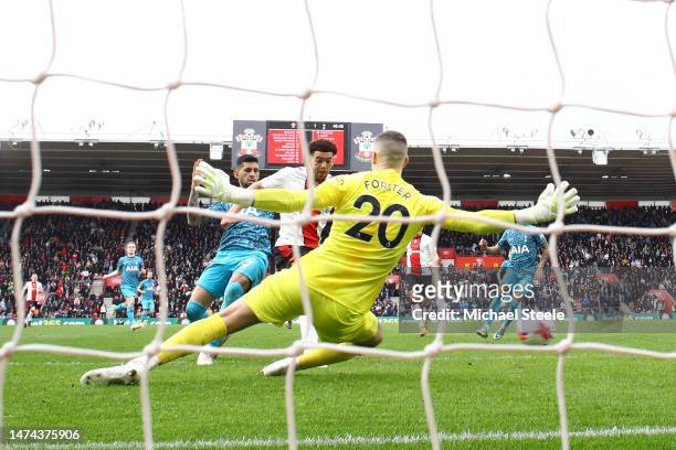 Che Adams of Southampton scores the team's first goal past Fraser Forster of Tottenham Hotspur during the Premier League match between Southampton FC...