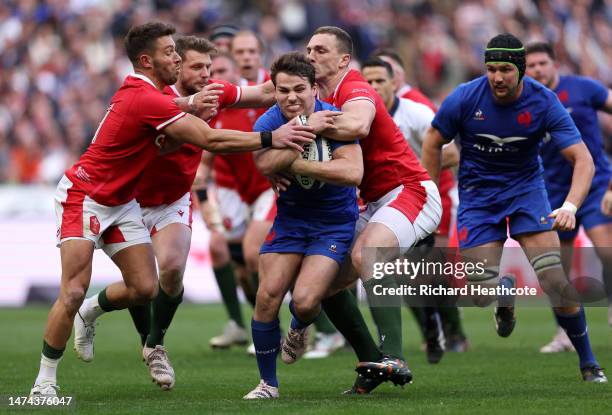 Antoine Dupont of France is challenged by Dan Biggar, Rhys Webb and George North of Wales during the Six Nations Rugby match between France and Wales...