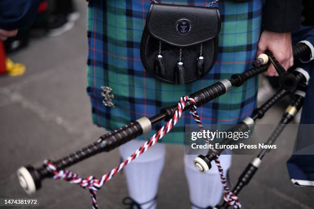 Detail of the tartan kilt and bagpipes of an Irish piper participating in the parade held in honor of St. Patrick, patron saint of Ireland, from the...