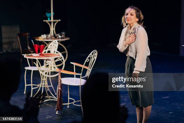 after the performance, the actress bow in front of the audience with a smile on her face - bowing stock pictures, royalty-free photos & images