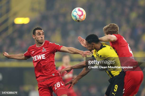Sebastien Haller of Borussia Dortmund contends for the aerial ball with Ellyes Skhiri and Timo Huebers of 1.FC Koeln during the Bundesliga match...