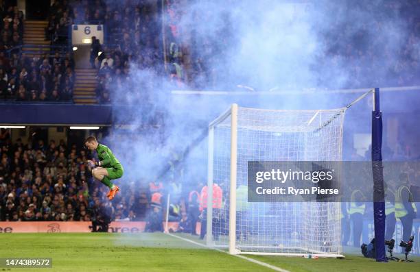 Jordan Pickford of Everton prepares for a penalty as fans of Everton use Smoke Flares during the Premier League match between Chelsea FC and Everton...