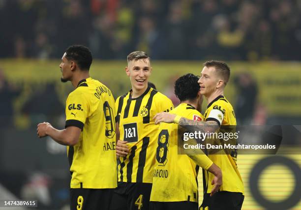 Marco Reus of Borussia Dortmund celebrates with teammates after scoring the team's sixth goal during the Bundesliga match between Borussia Dortmund...