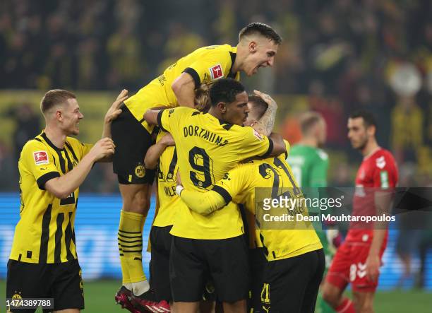Marco Reus of Borussia Dortmund celebrates with teammates after scoring the team's sixth goal during the Bundesliga match between Borussia Dortmund...
