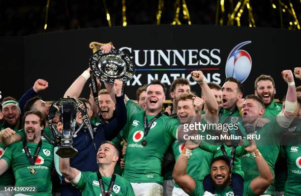 Johnny Sexton of Ireland lifts the Six Nations Trophy as James Ryan of Ireland lifts the Triple Crown Trophy after winning the Six Nations with a...