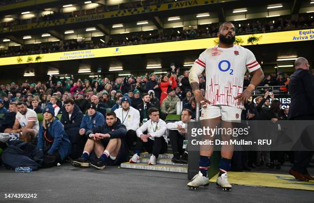 Kyle Sinckler of England looks dejected as they watch players of Ireland celebrate winning the Grand Slam after the Six Nations Rugby match between...