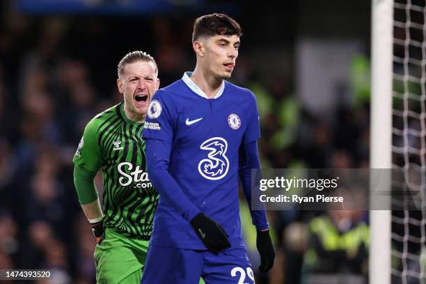 Jordan Pickford of Everton celebrates whilst Kai Havertz of Chelsea looks dejected following the Premier League match between Chelsea FC and Everton...