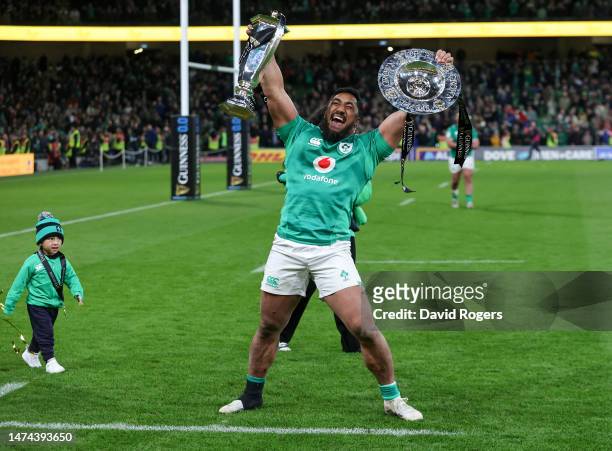 Bundee Aki of Ireland celebrates with the Six Nations Trophy and Triple Crown after a Grand Slam win after defeating England during the Six Nations...