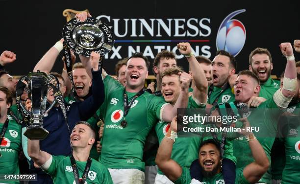 Johnny Sexton of Ireland lifts the Six Nations Trophy as James Bryan of Ireland lifts the Triple Crown Trophy after winning the Six Nations with a...