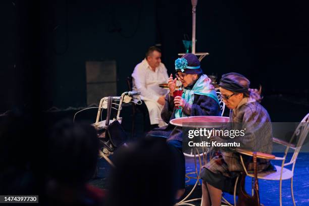 group of professional actors in costumes perform a play in front of the audience, the scene looks like a pastry shop - backstage audience stock pictures, royalty-free photos & images