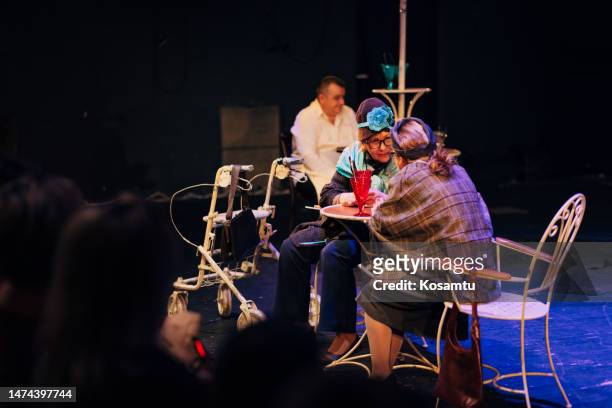 small group of professional actors in costumes perform a play in front of the audience, the scene looks like a coffee shop - backstage audience stock pictures, royalty-free photos & images