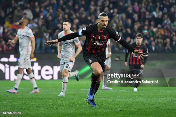 Zlatan Ibrahimovic of AC Milan celebrates after scoring the team's first goal from a penalty kick during the Serie A match between Udinese Calcio and...
