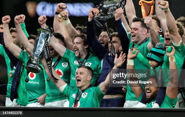 Johnny Sexton, the Ireland captain, holds the Six Nations trophy as Ireland celebrate their Grand Slam victory during the Six Nations Rugby match...