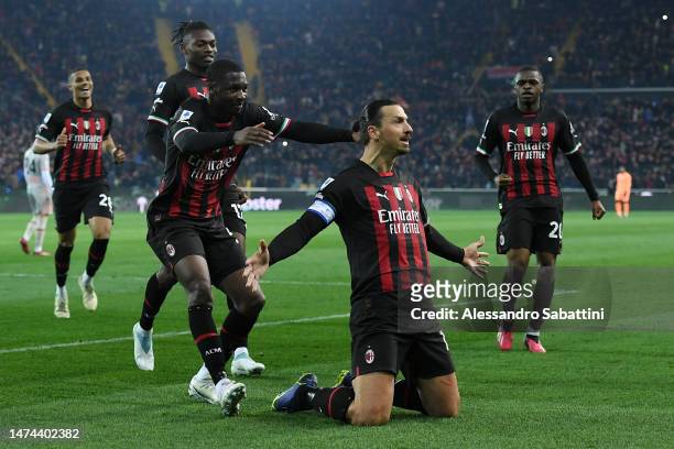 Zlatan Ibrahimovic of AC Milan celebrates with teammates after scoring the team's first goal from a penalty kick during the Serie A match between...
