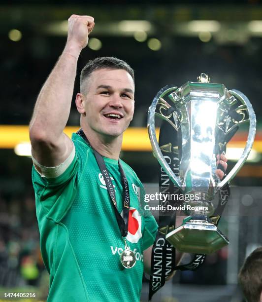 Johnny Sexton, the Ireland captain, holds the Six Nations trophy as he celebrates after their Grand Slam victory during the Six Nations Rugby match...