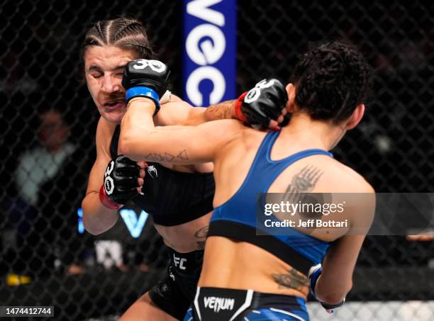 Casey O'Neill of Scotland and Jennifer Maia of Brazil trade punches in a flyweight fight during the UFC 286 event at The O2 Arena on March 18, 2023...