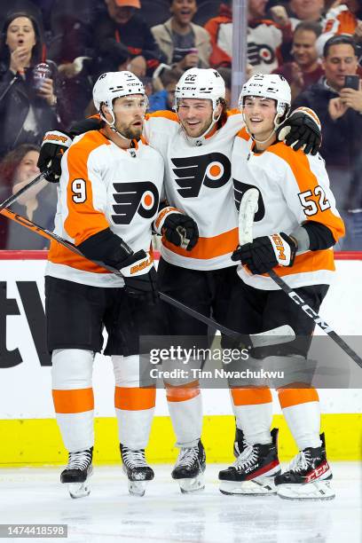 Ivan Provorov, Brendan Lemieux and Tyson Foerster of the Philadelphia Flyers react following a goal by Foerster during the second period against the...