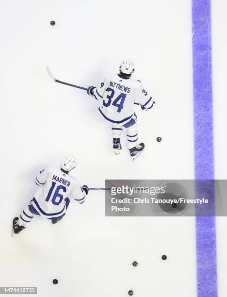Auston Matthews and Mitchell Marner of the Toronto Maple Leafs skate during warm-ups before a game against the Ottawa Senators at Canadian Tire...