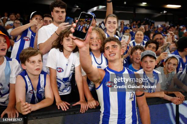 Harry Sheezel of the Kangaroos celebrates with fans after winning the round one AFL match between North Melbourne Kangaroos and West Coast Eagles at...