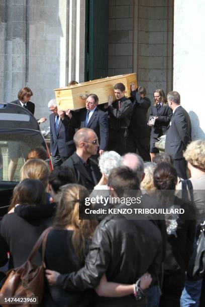 People hold the coffin of a member of the Dupont de Ligonnes family during the funeral ceremony on April 28, 2011 in the French western city of...