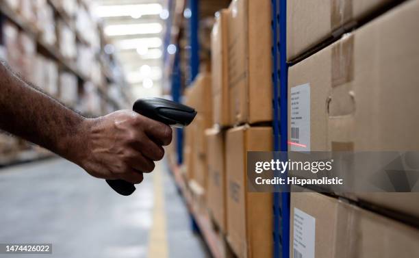 warehouse worker scanning a bar code on a box - inventory stock pictures, royalty-free photos & images