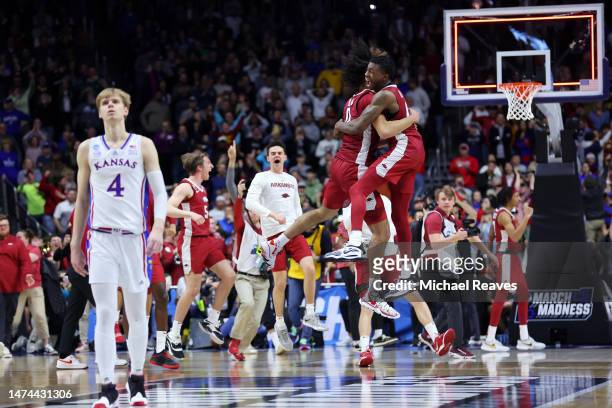 Anthony Black and Davonte Davis of the Arkansas Razorbacks celebrate after defeating the Kansas Jayhawks in the second round of the NCAA Men's...