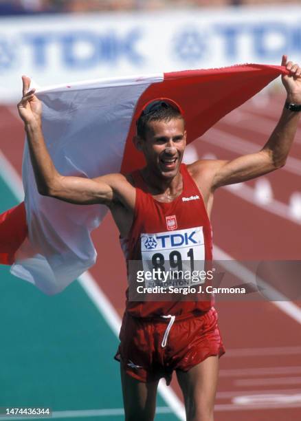 Robert Korzeniowski of Poland celebrates his victory competes in the 50km Walk of the IAAF World Championships at Commonwealth Stadium on August...