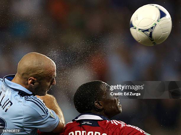 Aurelien Collin of Sporting Kansas City heads the ball towards the goal past Jalil Anibaba of Chicago Fire in the second half at Livestrong Sporting...