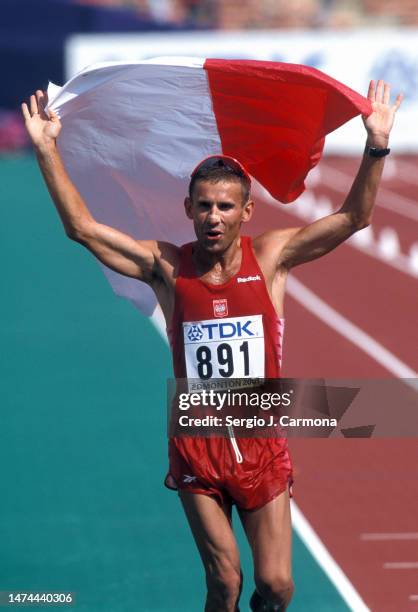 Robert Korzeniowski of Poland celebrates his victory competes in the 50km Walk of the IAAF World Championships at Commonwealth Stadium on August...