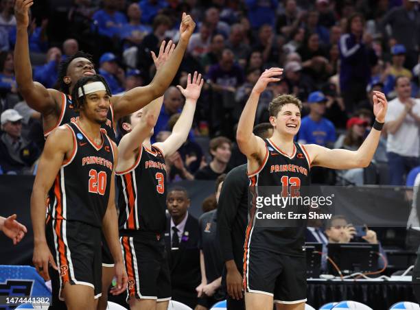 Tosan Evbuomwan, Ryan Langborg, and Caden Pierce of the Princeton Tigers react on the bench during the second half against the Missouri Tigers in the...