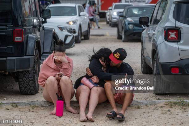 People sit together after partying at Clayton's Beach Bar and Grill during the South Padre Spring Break tradition on March 18, 2023 in South Padre...