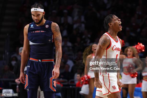 Marcus Sasser of the Houston Cougars celebrates as Johni Broome of the Auburn Tigers walks off the floor after Houston defeated Auburn 81-64 in the...