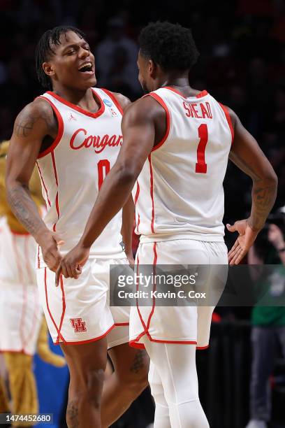 Marcus Sasser and Jamal Shead of the Houston Cougars celebrate after defeating the Auburn Tigers 81-64 in the second round of the NCAA Men's...