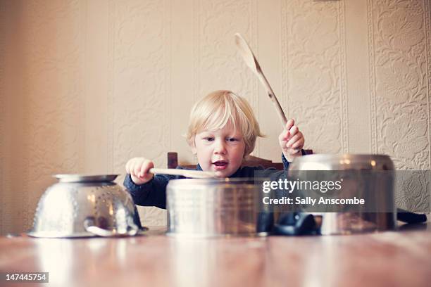 little boy using saucepans as drums - holding saucepan stock pictures, royalty-free photos & images