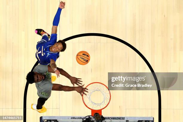 Josh Ojianwuna of the Baylor Bears and Josh Pierre-Louis of the UC Santa Barbara Gauchos battle for a rebound during the first round of the 2023 NCAA...