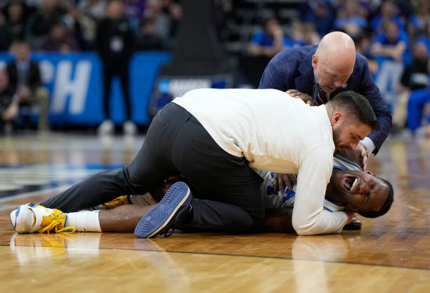 David Singleton of the UCLA Bruins is seen in pain after suffering an ankle injury during the second half against the Northwestern Wildcats in the...