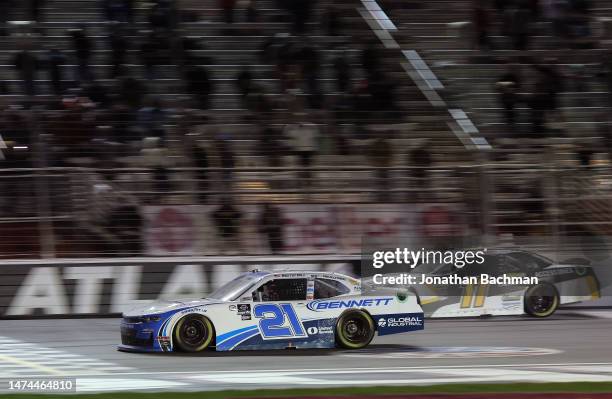 Austin Hill, driver of the Bennett Transportation Chevrolet, crosses the finish line to win the NASCAR Xfinity Series RAPTOR 250 at Atlanta Motor...