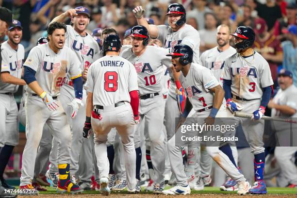 Trea Turner of The United States celebrates with teammates after hitting a grand slam during the eighth inning of a 2023 World Baseball Classic...