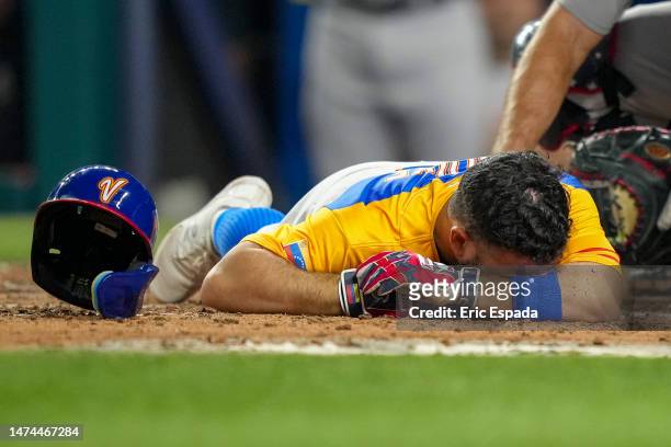 Jose Altuve of Venezuela lies on the ground after being hit by a pitch during the fifth inning during a 2023 World Baseball Classic Quarterfinal game...