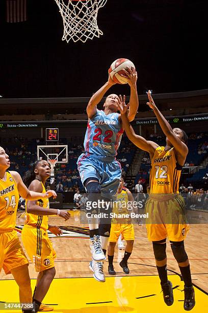 Armintie Price of the Atlanta Dream goes to the basket against Ivory Latta of the Tulsa Shock during the WNBA game on June 29, 2012 at the BOK Center...