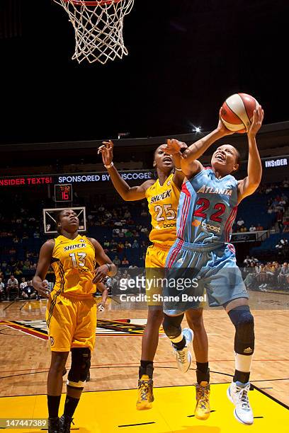 Armintie Price of the Atlanta Dream shoots past Glory Johnson of the Tulsa Shock during the WNBA game on June 29, 2012 at the BOK Center in Tulsa,...