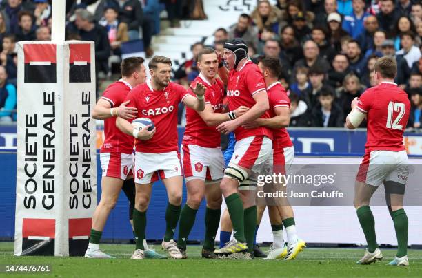 Dan Biggar, George North, Adam Beard of Wales celebrate a try during the Guinness Six Nations Rugby match between France and Wales at Stade de France...