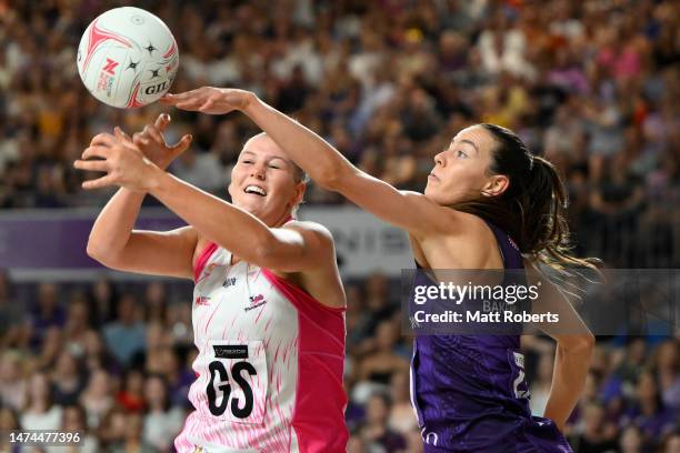 Lucy Austin of the Thunderbirds competes for the ball against Ruby Bakewell-Doran of the Firebirds during the round one Super Netball match between...