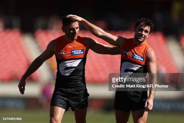 Stephen Coniglio and Brent Daniels of the Giants celebrate victory after the round one AFL match between Greater Western Sydney Giants and Adelaide...