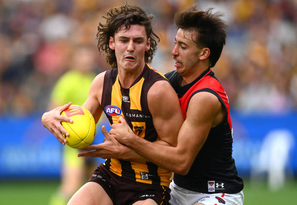 Connor MacDonald of the Hawks is tackled by Nic Martin of the Bombers during the round one AFL match between Hawthorn Hawks and Essendon Bombers at...