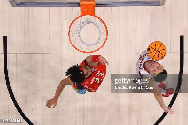 Jahvon Quinerly of the Alabama Crimson Tide goes up against Ian Martinez of the Maryland Terrapins in the second round of the NCAA Men's Basketball...