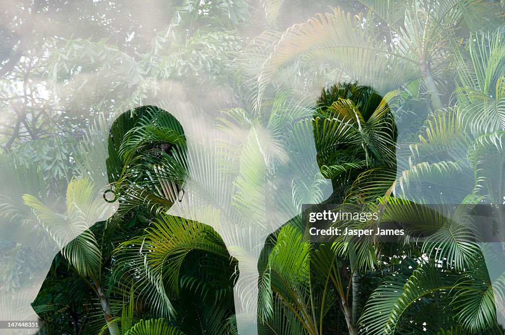 Double exposure of man,woman and trees