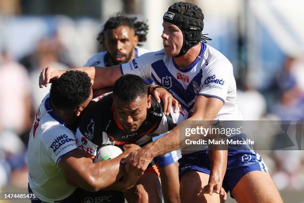 David Nofoaluma of the Wests Tigers is tackled during the round three NRL match between Canterbury Bulldogs and Wests Tigers at Belmore Sports Ground...