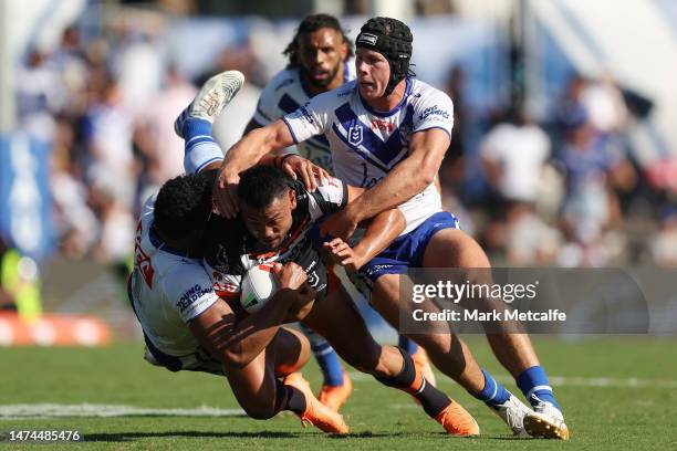 David Nofoaluma of the Wests Tigers is tackled during the round three NRL match between Canterbury Bulldogs and Wests Tigers at Belmore Sports Ground...