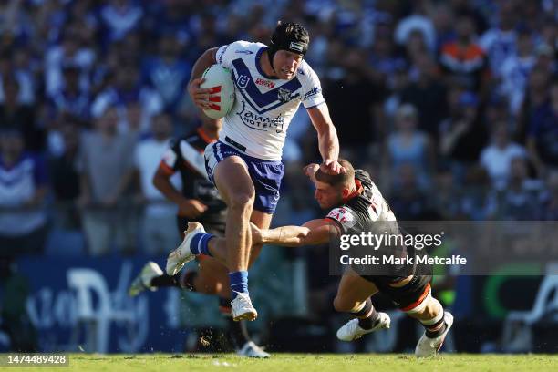 Matt Burton of the Bulldogs makes a break to score a try during the round three NRL match between Canterbury Bulldogs and Wests Tigers at Belmore...